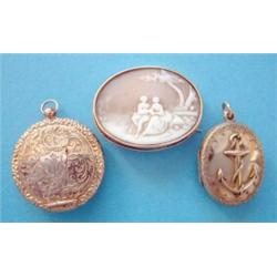 A Victorian gold oval locket pendant, the front with applied ships anchor, the reverse foliate en...
