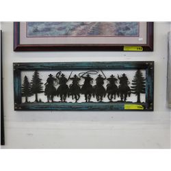 Framed metal silhouette cutout of cowboys