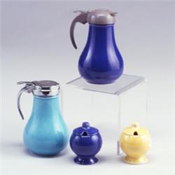 4 FIESTA pieces: two syrup pitchers with Drip-Cut pourers, one of grey plastic on cobalt base wit...