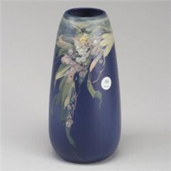 WELLER Blue & Decorated bullet-shaped vase, painted with berries and leaves in pastel tones. Unma...