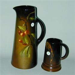 Two WELLER Louwelsa pieces: tall pitcher painted by Frank Ferrell with a branch of cherries, and...
