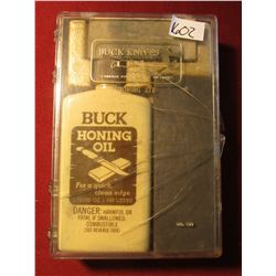 1602. BU ck Honing Oil and two stones in original box.