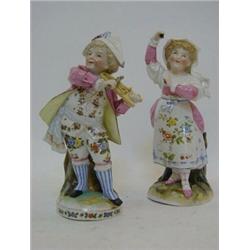 A PAIR OF FIGURES, c.1890, continental porcelain, boy playing hurdy gurdy, girl with castanets, r...