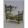 Image 1 : A TOY BED c.1880, half tester, extruded brass tubing, stuffed mattress, length 14cm  50-70...