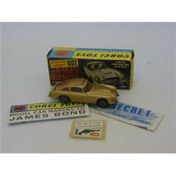 A CORGI TOYS JAMES BOND ASTON MARTIN DB5, No.261, gold livery, metal roof, two figures, (facsimil...