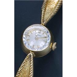 Omega, a lady's 18ct gold bracelet wristwatch, circa 1960, the silvered dial with baton numerals...