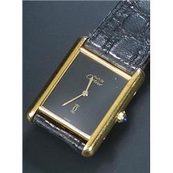 Must de Cartier 'Tank', a lady's silver-gilt wristwatch, circa 1970, the black dial with baton ha...
