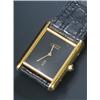 Image 1 : Must de Cartier 'Tank', a lady's silver-gilt wristwatch, circa 1970, the black dial with baton ha...