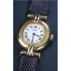 Must de Cartier, a lady's silver-gilt round wristwatch, circa 1980, ref.590002, the cream dial wi...