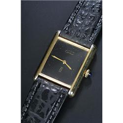 Must de Cartier, Tank, a lady's silver-gilt wristwatch, circa 1990, the black dial with baton han...