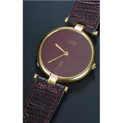 Must de Cartier, a mid size silver-gilt round wristwatch, the maroon dial with baton hands, round...