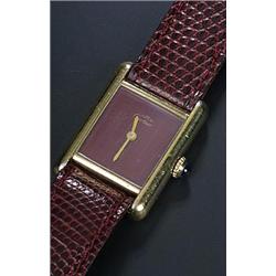 Must de Cartier, Tank, a lady's silver-gilt wristwatch, circa 1970, the maroon dial with baton ha...