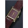 Image 1 : Must de Cartier, Tank, a lady's silver-gilt wristwatch, circa 1970, the maroon dial with baton ha...