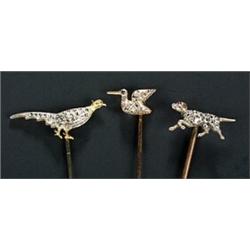 Three Victorian rose diamond 'sporting' stick pins, comprising; a 'hound' with cabochon ruby eye,...