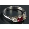 Image 1 : An 18ct white gold, ruby and diamond three stone ring, centred with an oval mixed-cut ruby approx...