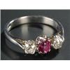 Image 1 : An 18ct white gold, ruby and diamond three stone ring, centred with an oval mixed-cut ruby approx...