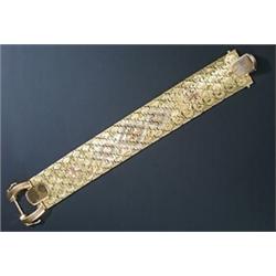 A Continental tri-colour broad bracelet, designed as a honeycomb of shaped-oval panels engraved w...