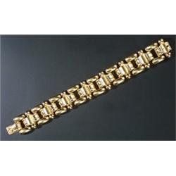 An 14ct gold broad bracelet in the form of shaped and plain blocks and round beads, London 2002,...