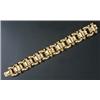Image 1 : An 14ct gold broad bracelet in the form of shaped and plain blocks and round beads, London 2002,...
