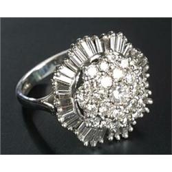 A modern 18ct white gold and diamond 'ballerina' cluster ring, centred with a round brilliant dia...
