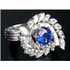Image 1 : A modern French platinum sapphire and diamond cluster ring, centred with a round mixed-cut sapphi...