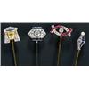 Image 1 : A group of four Art Deco diamond and gem stick pins, comprising; an Egyptian mask with a calibre...