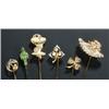 Image 1 : A group of six gold and gem stick pins, comprising; a carved green chalcedony pin decorated with...