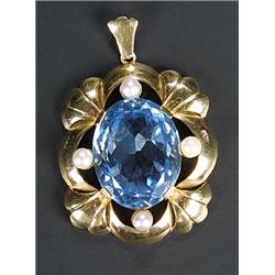 An 18ct gold, cultured pearl and large oval pale blue synthetic spinel pendant, of lobed floral o...