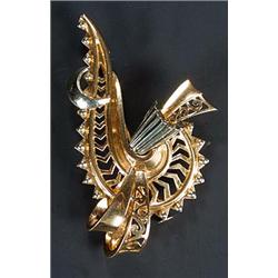 A modern Continental bi-colour pierced scroll and ribbon brooch, stamped '0750'...