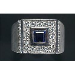 A Continental sapphire and diamond square cluster ring, centred with a square trap-cut sapphire w...