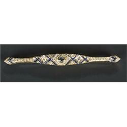 A modern sapphire and diamond bar brooch, the shaped panel set with round brilliant and eight-cut...