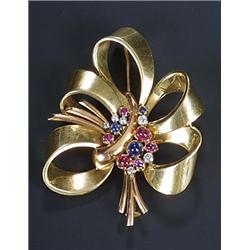 A 1940s gem brooch designed as a tied ribbon spray with a central cluster of cabochon sapphires a...