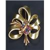 Image 1 : A 1940s gem brooch designed as a tied ribbon spray with a central cluster of cabochon sapphires a...