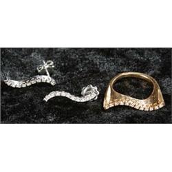 A pair of modern diamond stud earrings and a matching ring, each of wavy scroll design, the white...