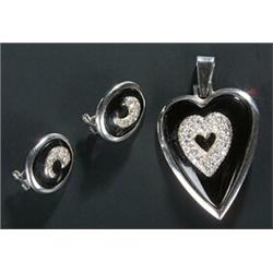 A black onyx and diamond pendant and a pair of similar earrings, the heart shaped pendant centred...