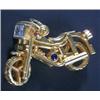 Image 1 : A Continental gem-set 'motorbike' pendant, set with rubies, a sapphire and a cubic zirconia, stam...