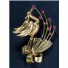 Image 1 : An Italian gold and ruby brooch, in the form of a stylised stork flying over a ribbon tied flower...