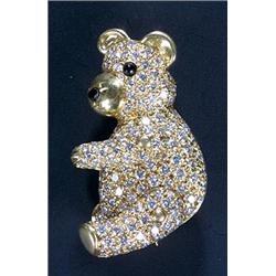 A diamond 'teddy bear' brooch, pave set throughout with round brilliant diamonds and with a black...