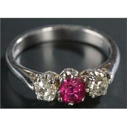 A modern 18ct white gold, ruby and diamond three stone ring, centred with a cushion-shaped mixed-...