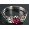 Image 1 : A modern 18ct white gold, ruby and diamond three stone ring, centred with a cushion-shaped mixed-...