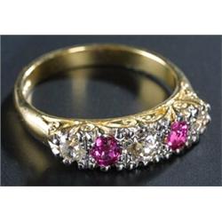 A modern 18ct gold, ruby and diamond five stone scroll-cast half-hoop ring, the three old-cut dia...