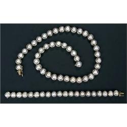 A cultured pearl and diamond necklace and a matching bracelet;  each in the form of a row of roun...