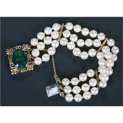 A cultured pearl three row bracelet on green tourmaline clasp, the uniform breads approx. 6.5mm d...