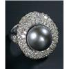 Image 1 : A black Tahitian cultured pearl and diamond oval cluster ring, centred with a round bead approx.1...