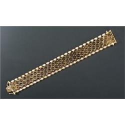 A modern 18ct gold fancy link broad bracelet, designed a honeycomb with textured borders, London...