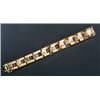 Image 1 : A modern 18ct bi-colour gold broad block bracelet, of articulated three row design with a central...