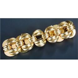 A modern Continental broad bracelet, designed as open lobed-round panels, stamped '0750', 79.4g...