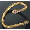 Image 1 : A modern Middle Eastern ruby and diamond curb link torque bangle with serpent terminals set with...