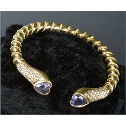 An iolite and diamond torque bangle, the hollow bangle with ropework decoration and heart-shaped...