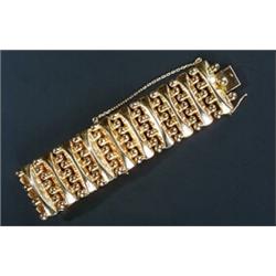 A modern 18ct gold broad bracelet, designed as alternate shaped-batons and beads to run across th...
